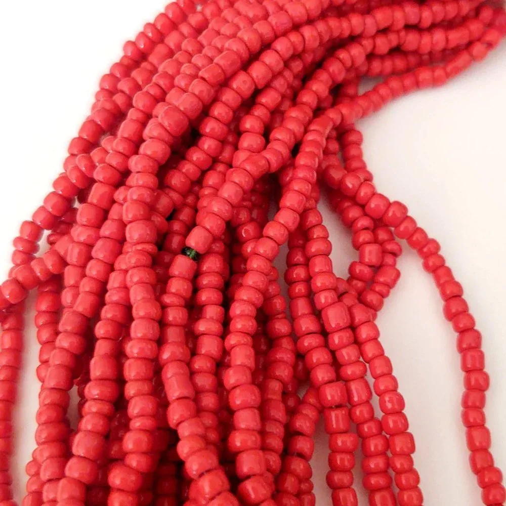 Layered orange beaded necklace with old coin toggle closure